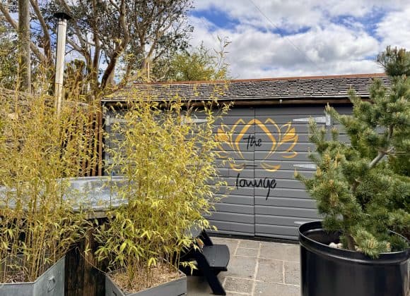 'The lotus Lounge', outdoor seating, potted plants, and a scenic sky at Brightham House.
